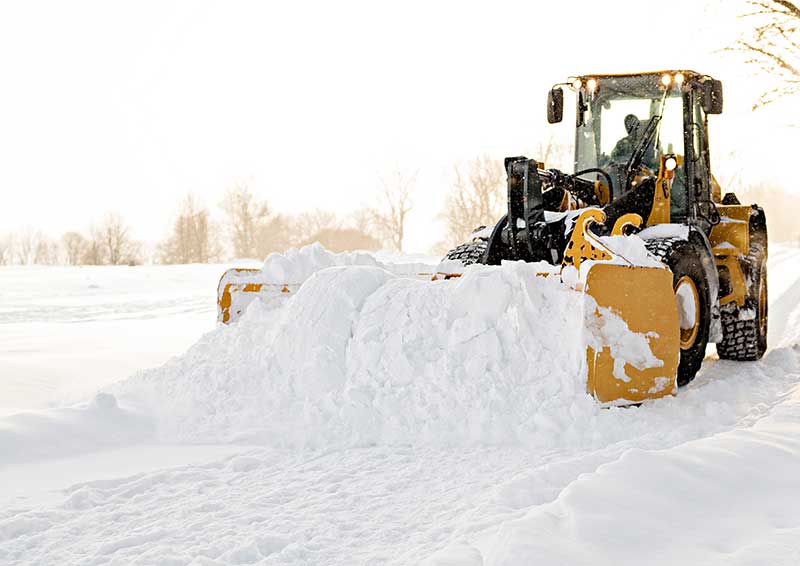 Equipment plowing snow